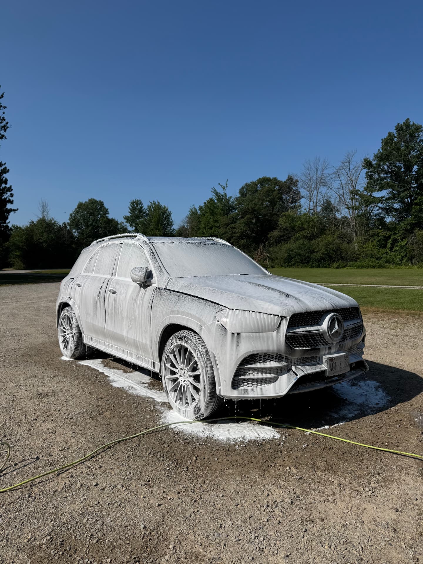 Mercedes SUV covered in thick foam during a professional hand wash detail